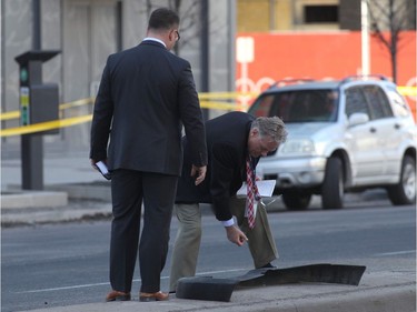 Forensic police officers look a car bumper after a truck drove up on the curb and hit several pedestrians in Toronto, Ontario, on April 23, 2018.  At least nine people were killed and 16 others wounded Monday when a driver rammed his rental van into a crowd of pedestrians in downtown Toronto, police said, without revealing a possible motive."This is going to be a complex investigation," deputy police chief Peter Yuen told reporters. "We have one person in custody and the investigation is ongoing.""We can confirm for you tonight right now we have nine people that are dead, 16 injured," Yuen said.