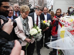 Ontario Premier Kathleen Wynne and Toronto Mayor John Tory brings flowers on April 24, 2018 to a makeshift memorial for victims in the van attack in Toronto, Ontario.