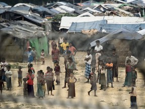 Rohingya refugees gather near their shelters in the "no man's land" behind Myanmar's boder lined with barb wire fences in Maungdaw district, Rakhine state bounded by Bangladesh on April 25, 2018.