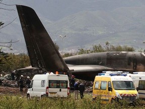 Firefighters and civil security officers work at the scene of a fatal military plane crash in Boufarik, near the Algerian capital, Algiers, Wednesday, April 11, 2018. Algerian emergency services say 181 people have been killed in a military plane crash and some survivors have been rescued.