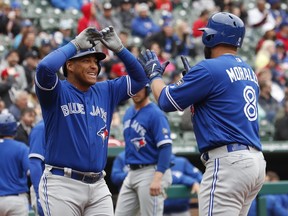 Toronto Blue Jays' Kendrys Morales (8) is congratulated by Yangervis Solarte, left, after his three-run home run during the first inning of a baseball game, Sunday, April 8, 2018, in Arlington, Texas.