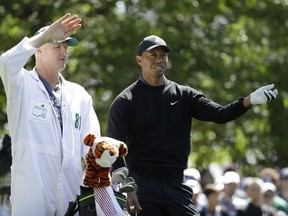 Tiger Woods looks over a shot on the fourth hole during the first round at the Masters golf tournament Thursday, April 5, 2018, in Augusta, Ga.