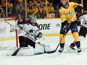 Nashville Predators center Colton Sissons (10) watches as a shot hits Colorado Avalanche goaltender Andrew Hammond (35) during the second period in Game 5 of an NHL hockey first-round playoff series Friday, April 20, 2018, in Nashville, Tenn.