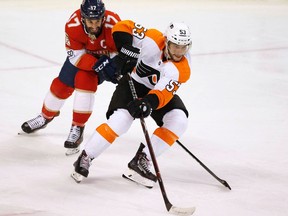 Philadelphia Flyers defenceman Shayne Gostisbehere and Florida Panthers centre Derek MacKenzie battle for the puck during an NHL game on March 4, 2018