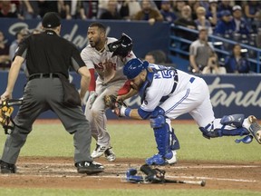 Toronto Blue Jays catcher Russell Martin puts the tag on Boston Red Sox's Eduardo Nunez for the out as home plate umpire Scott Barry looks on in the ninth inning American League MLB baseball game action in Toronto on Tuesday April 24, 2018.