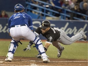 Chicago White Sox Yoan Moncada is out at the plate with the tag by Toronto Blue Jays catcher Luke Maile in the seventh inning of their American League MLB baseball game in Toronto on Tuesday April 3, 2018.