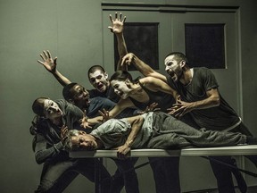 Jonathon Young (on table) with the cast of "Betroffenheit," a contemporary dance-theatre hybrid that explores themes of PTSD, grief and addiction. The show will be performed at the NAC April 6-7, 2018.