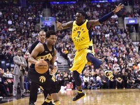 Raptors guard Kyle Lowry moves past the Pacers' Darren Collison during first-half action in Toronto on Friday night.