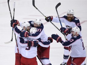 Columbus Blue Jackets left wing Artemi Panarin (9) celebrates his game-winning goal in overtime with Nick Foligno (71), Brandon Dubinsky (17), Ian Cole (23) and David Savard (58) in Game 1 of an NHL first-round hockey playoff series against the Washington Capitals, Thursday, April 12, 2018, in Washington.