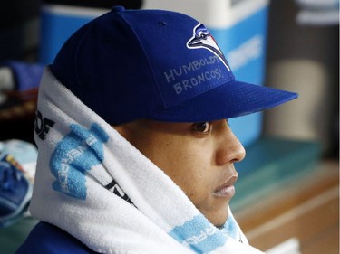 Toronto Blue Jays starting pitcher Marcus Stroman watches from the dugout during the first inning of a baseball game against the Texas Rangers, Saturday, April 7, 2018, in Arlington, Texas. Stroman had the name of Humboldt Broncos junior hockey team written on his cap in memory of those killed in their bus crash.