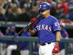 Rangers catcher Juan Centeno blows on the end of his bat after swinging for a strike during the fourth inning of Saturday's contest against the Blue Jays.