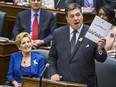 Ontario Finance Minister Charles Sousa delivers the provincial budget at the Ontario Legislature, while Ontario Premier Kathleen Wynne looks on in Toronto, Ont. on Wednesday March 28, 2018.