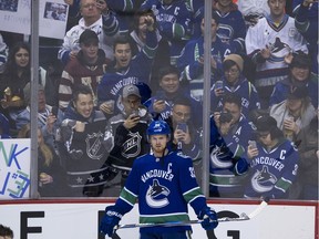 Canucks fans line the boards for a photo as the team's Henrik Sedin takes to the ice before playing the Arizona Coyotes in a regular-season NHL game at Rogers Arena in Vancouver on April 5.