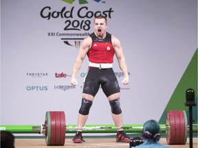 Canada's Boady Santavy reacts after lifting 196kg in the clean and jerk on his way to a silver medal in the men's 94kg weightlifting finals at the Commonwealth Games Sunday, April 8, 2018  in Gold Coast, Australia.