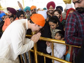 Prime Minister Justin Trudeau is greeted by crowds as he visits the Golden Temple in Amritsar, India on February 21, 2018. The prime minister's executive arm says it hasn't paid a dime for any clothes, shoes or fashion accessories worn by Justin Trudeau or his family since he took office. The Privy Council Office answered a written order paper question this week saying it hasn't paid for any clothes, shoes, other apparel or fashion accessories since November 4, 2015, a period of time that includes the state visit to India in February where the family's Bollywood-esque fashions were widely criticized as over the top at best, and cultural appropriation at worst.