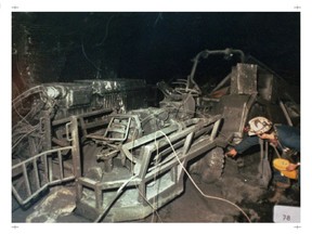 PICTOU, N.S.,--In this RCMP file photo, an investigator examines an ambulance tractor inside the devastated Westray mine. The picture was one of the many entered as evidence at the trial of two former mine managers from the ill-fated colliery. l995