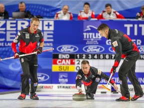 Canada skip Brad Gushue delivers his shot as lead Geoff Walker, left, and second Brett Gallant look on as they take on Switzerland at the men's World Curling Championship in Las Vegas on Sunday, April 1, 2018.