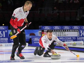 Canadian lead Geoff Walker, left, watches as skip Brad Gushue releases a rock during Tuesday's game against South Korea in Las Vegas.