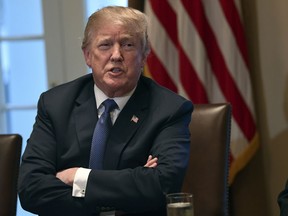 President Donald Trump speaks in the Cabinet Room of the White House in Washington, Monday, April 9, 2018, at the start of a meeting with military leaders. Federal agents raided the office of Trump's personal attorney Michael Cohen, seizing records on topics including a $130,000 payment made to a porn actress who says she had sex with Trump more than a decade ago. The move ignited the president's anger, with Trump calling it a "disgrace" that federal agents "broke into" the office of his personal attorney. He also called special counsel Robert Mueller's investigation "an attack on our country."