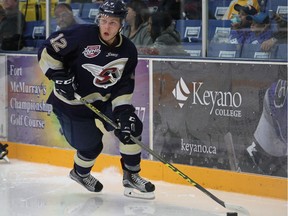 Conner Lukan, pictured during his time with the Spruce Grove Saints, attempts to bring the puck out from behind his opponents' net during AJHL action at the Casman Centre in Fort McMurray on Sept. 12, 2015.