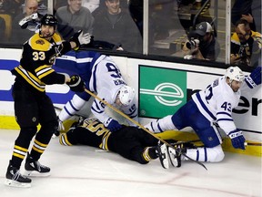 In this April 12, 2018, file photo, Boston Bruins defenseman Zdeno Chara (33) complains to an offical about a hit on teammate Tommy Wingels (57) by Toronto Maple Leafs center Nazem Kadri (43) as Maple Leafs center Mitchell Marner (16) starts to get up during the third period of Game 1 of an NHL hockey first-round playoff series in Boston. Kadri was suspended three games for the hit.