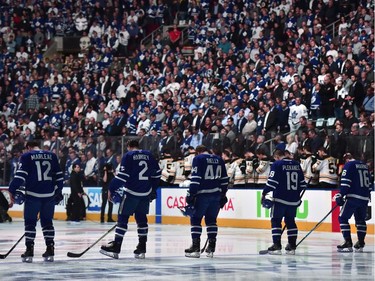 Players and fans stand for a moment of silence, after nine people died and 16 others were injured when a van mounted a sidewalk and struck multiple pedestrians along a stretch of one of Toronto's busiest streets, before first period NHL round one playoff hockey action against the Boston Bruins in Toronto on Monday, April 23, 2018.