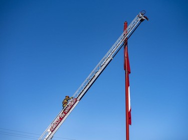 The Humboldt Fire Department lowers a large Canadian flag to half-mast.