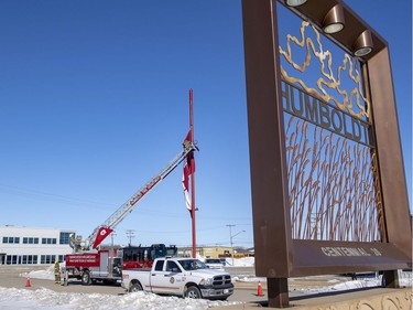 The Humboldt Fire Department lowers a large Canadian flag to half-mast.