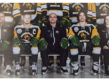 Head coach and general manager Darcy Haugan, centre, is shown in team photo of the 2016-17 Humboldt Broncos hockey team as it hangs in Elgar Petersen Arena in Humboldt, Sask., on Saturday, April 7, 2018. The head coach of the Humboldt Broncos hockey team is among the dead.