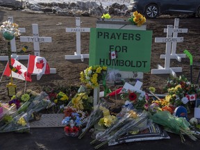 Hockey sticks, messages and other items at a memorial at the intersection of a fatal bus crash that killed 16 members of the Humboldt Broncos hockey team,