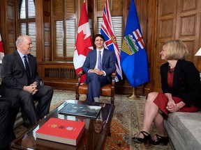 Prime Minister Justin Trudeau, B.C. Premier John Horgan, left, and Alberta Premier Rachel Notley, sit in Trudeau's office on Parliament Hill for a meeting on the deadlock over Kinder Morgan's Trans Mountain pipeline expansion, in Ottawa on Sunday, April 15, 2018.