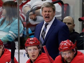 FILE - In this Feb. 6, 2018, file photo, Carolina Hurricanes coach Bill Peters reacts during the second period of an NHL hockey game against the Philadelphia Flyers in Raleigh, N.C. Peters has resigned as the Hurricanes' coach after four seasons and no playoff berths. Peters announced his decision Friday, April 20, 2018, through the team, saying in a statement that "this is a good time to move on."