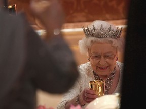 Britain's Queen Elizabeth raises her glass during speeches at The Queen's Dinner, during the Commonwealth Heads of Government Meeting at Buckingham Palace in London, Thursday, April 19, 2018.