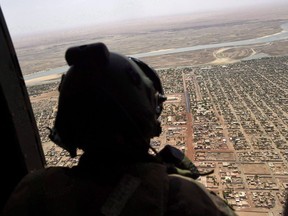 A French soldier stands inside a military helicopter during a visit by French President Emmanuel Macron to the troops of Operation Barkhane, France's largest overseas military operation, in Gao, northern Mali, Friday, May 19, 2017. (THE CANADIAN PRESS/AP-Christophe Petit Tesson, POOL)