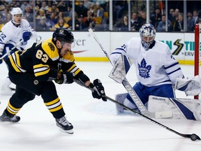 Boston Bruins' Brad Marchand (63) gains control of the puck in front of Toronto Maple Leafs' Frederik Andersen (31), of Denmark, during the second period of Game 5 of an NHL hockey first-round playoff series in Boston, Saturday, April 21, 2018. The Maple Leafs won 4-3.