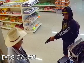 A would-be robber points a gun at a customer at a butcher shop in Mexico.