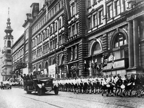 TO GO WITH AFP STORY BY Pierre Feuilly (FILES) This picture shows German Nazi troops and young Nazis parade in a street of Vienna on March 15, 1938 after the Anschluss, the invasion of Austria by the troops of the German Wehrwacht. Italy's anti-immigration party The League has sparked a furore in the town of Cologne Monzese, near Milan, after its councillors sponsored a re-enactment of the Nazi occupation with locals dressed up as SS officers.