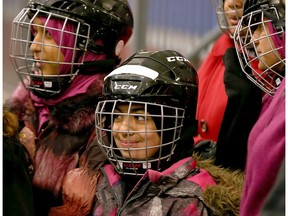 Kids are all smiles they head to the Jim Durrell Arena to learn how to skate. Many of the new Canadians have begun learning about the game of hockey.