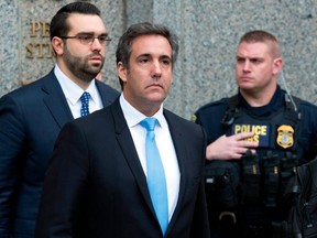 FILE - In a Monday, April 16, 2018, file photo, Michael Cohen, President Donald Trump's personal attorney, center, leaves federal court, in New York. Federal prosecutors said they can give President Donald Trump's personal lawyer, Cohen, copies of materials seized from him by the FBI by May 11. They notified a New York judge Wednesday.