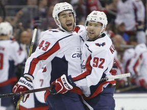 Washington Capitals' Tom Wilson, left, celebrates his goal against the Columbus Blue Jackets with teammate Evgeny Kuznetsov, of Russia, during Game 4 of an NHL first-round hockey playoff series Thursday, April 19, 2018, in Columbus, Ohio.