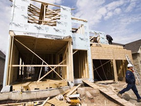 Construction workers build a new home in Oakville on April 14, 2009. THE CANADIAN PRESS/Nathan Denette