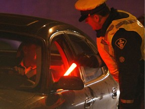 Sergeant Don Hickey interviews drivers during a ride program at the Maitland 417 west bound ramp in Ottawa, December 22, 2009.