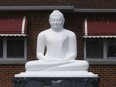 Buddha statue that has been restored after it was decapitated in March sits at the Hilda Jayewardenaramaya Buddhist Temple in Ottawa Monday April 30, 2018.  Tony Caldwell