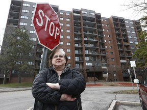 Joumana Azzi in front of 2630 Southvale Cres., where owners face a huge increase in their monthly condo fees.