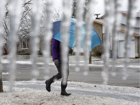 A woman walks in the ice storm.