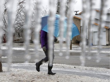 A woman walks in a ice storm in Ottawa Monday April 16, 2018.