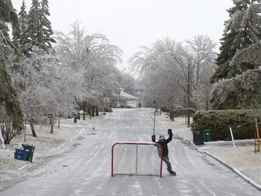 Tomislav Brennan plays hockey and skates on Fairmeadow Cres. in Ottawa Monday April 16, 2018. A ice storm over night covered the streets of Ottawa with enough ice to be able to skate. Tony Caldwell