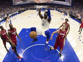 In this photo taken with a fisheye lens, Philadelphia 76ers' Joel Embiid, of Cameroon, dunks the ball during the first half in Game 5 of a first-round NBA basketball playoff series against the Miami Heat, Tuesday, April 24, 2018, in Philadelphia. The 76ers won 104-91.