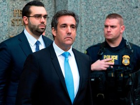 FILE - In a Monday, April 16, 2018, file photo, Michael Cohen, President Donald Trump's personal attorney, center, leaves federal court, in New York. Cohen filed papers in federal court in Los Angeles Wednesday, April 25, 2016, saying he will assert his Fifth Amendment rights, stating that he will exercise his constitutional right against self-incrimination in a lawsuit brought by porn actress Stormy Daniels, who said she had an affair with Trump.