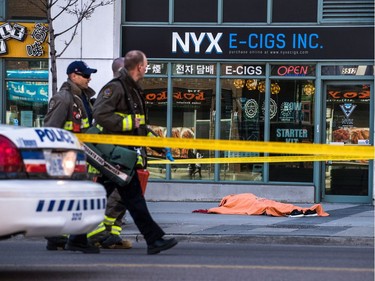 A body lies covered on the sidewalk in Toronto after a van mounted a sidewalk crashing into a number of pedestrians on Monday, April 23, 2018.